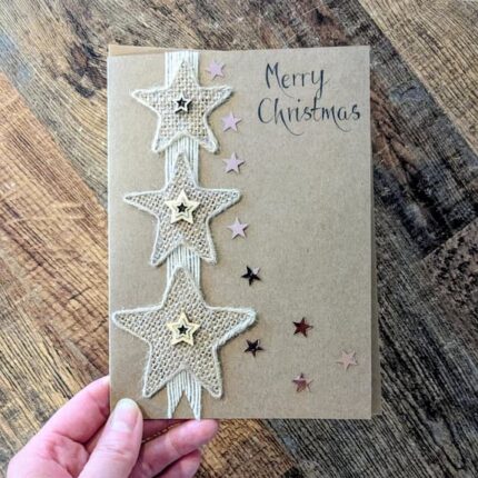 Handmade Rustic Christmas Card with Burlap Stars on Kraft Paper.