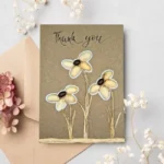 Amazing handmade Thank You Floral card made of pistachio shells and coffee beans on brown paper.