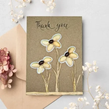 Amazing handmade Thank You Floral card made of pistachio shells and coffee beans on brown paper.