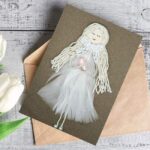 Beautiful Handmade Card For All New Moms made of a Pure White Feathers on brown envelope.