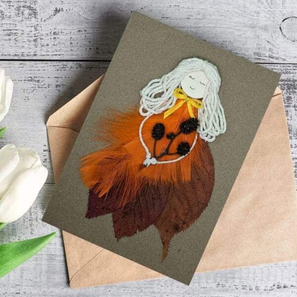 Beautiful Handmade Card For Her with Orange Feathers and wife cotton strings for Special Occasions on brown paper.