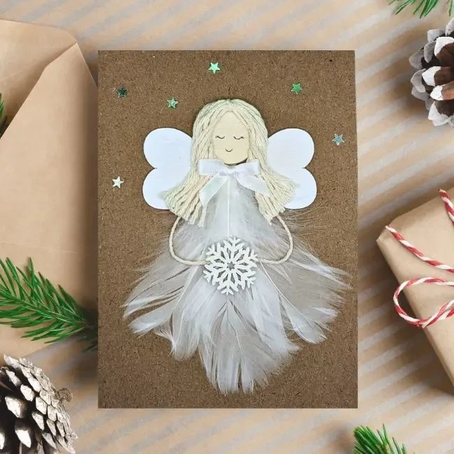 Beautiful Handmade Christmas Card for Her With an Angel Beautiful Handmade Christmas Card for Her With an Angel made of white feathers and wooden wings.