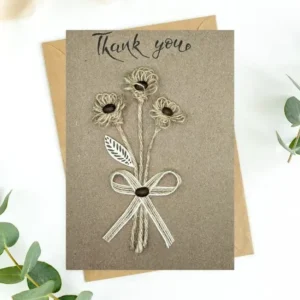 Beautiful Handmade Thank You Card made of a base cardstock, three string flowers with coffee beans, cotton leaf, and a tied string bow.