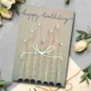 Bespoke and Personalised Handmade Card: Charm of Birthday Candles. Made of Coffee beans, cotton string on brown paper with cotton bow.