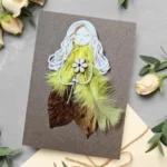 Handmade and fancy birthday card for her made of leaf and yellow feathers.
