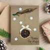 Handmade Personalised Christmas card featuring a dried orange slice, white stars, and a bow.
