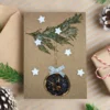 Handmade Personalised Christmas card features one dried orange slice, a branch, and stars.