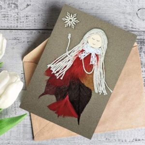 Best romantic birthday card for her birthday showcasing a girl in a red dress with feathers, made from dry leaves and feathers for a unique design.