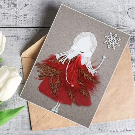 A beautifully crafted best romantic birthday card for her birthday with a girl in a red dress, decorated with dry leaves and feathers for a romantic theme.