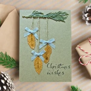 Best Rustic Handcrafted Christmas Card with Dried Leaves image 1 Best Rustic Handcrafted Christmas card with three dried leaves and blue bows and Christmas wishes.