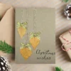 Best Rustic Handcrafted Christmas Card made in the UK with dried leaves, gold bows and the text 'Christmas wishes'.
