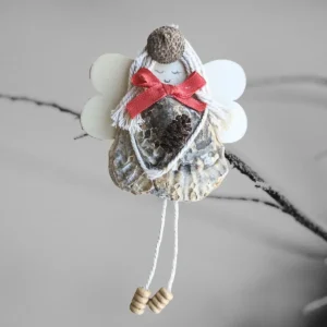 Charming and Unique Handmade Seashell Angel Unique Charming Handmade Seashell Angel made of seashell, wooden wings and corn.