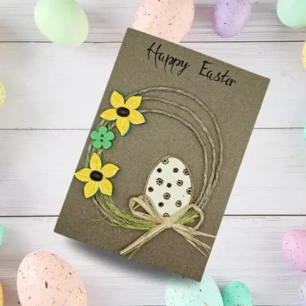 Charming handmade Easter card featuring a colourful egg made of cardstock, accompanied by three flowers crafted from felt, paper, and coffee beans.