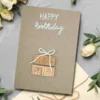 Charming Homemade Birthday Card – Celebrate with a Truly Unique Design. Made of cork and white cotton bow on brown paper.