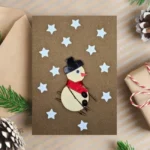Easy Handmade Christmas Card decorated with a skiing snowman and stars. Made in the UK.