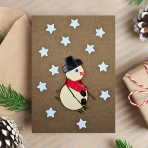 Easy Handmade Christmas Card Idea Decorate with Snowman Easy Handmade Christmas Card decorated with a skiing snowman and stars. Made in the UK.