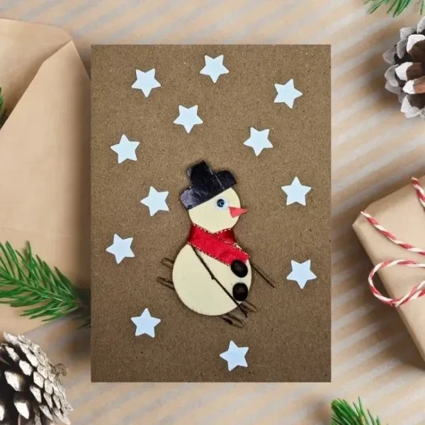 Easy Handmade Christmas Card Idea Decorate with Snowman Easy Handmade Christmas Card decorated with a skiing snowman and stars. Made in the UK.
