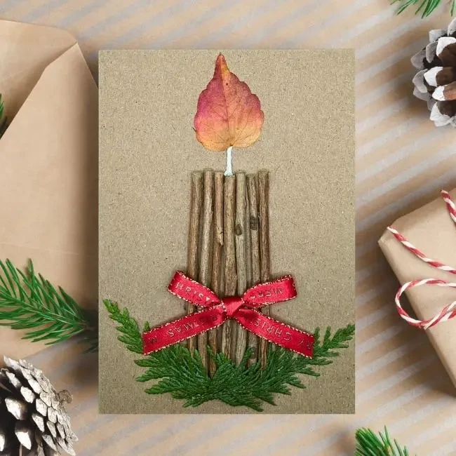 Elegant Handmade Christmas Card With Candle Ornament Elegant handmade Christmas card featuring a unique candle ornament crafted from wood, leaves, and thuja twigs in the UK.