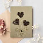 Elegant Handmade Thank You Greeting Card features three hearts made of coffee and cotton string