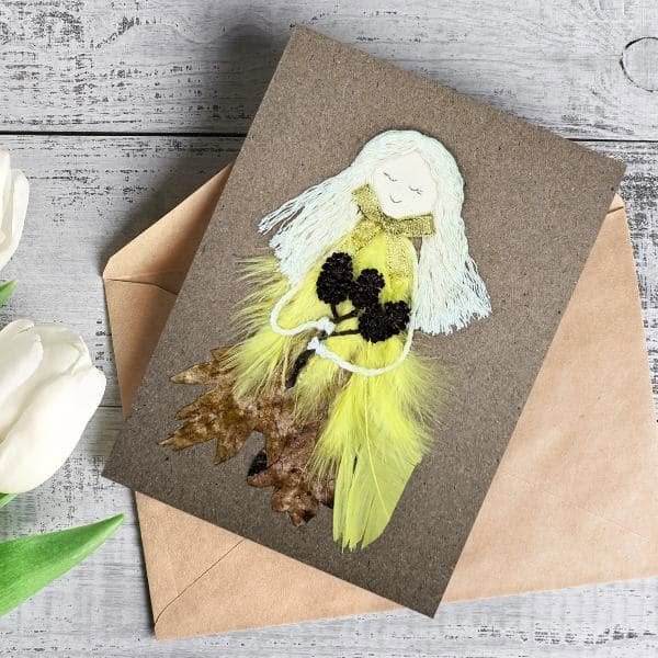 Enchanted Handmade with Love Card for Her Enchanted Handmade with Love Card for Her made of dry leaf, yellow bright feathers, cotton string and small cones.