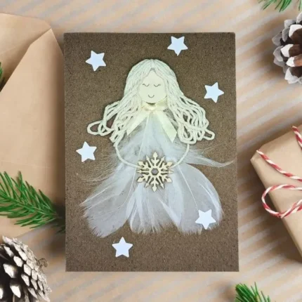 Handmade beautiful Angel Christmas card with white Angel made of feathers and snowflake.