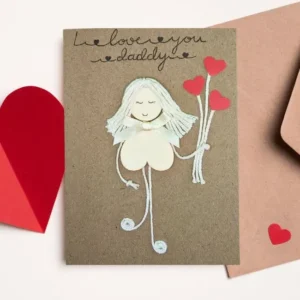 Handmade and Heartfelt I Love You Dad Card The Handmade and Heartfelt I Love You Dad Card features a girl made of wood with heart-shaped balloons on brown paper, complemented by red heart cut-outs for extra love.