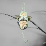 The image depicts a unique Shell Christmas ornament made from an oyster shell, featuring a heart that has the words 'I love you' written on it.