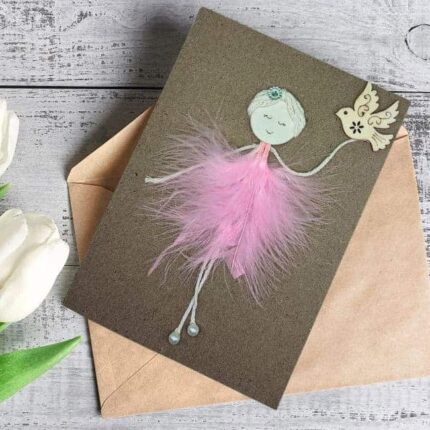 Handmade Ballerina Birthday Card for Wife made of pink feathers and wooden bird on brown paper.