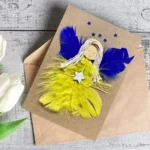 Handmade Birthday Card for Girlfriend - Best Girlfriend Card made of yellow and blue feathers, with one big and five small stars above.