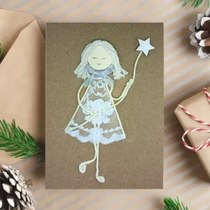 Handmade Christmas Card for Grandparents with a smiling girl made from lace fabric holding a star.