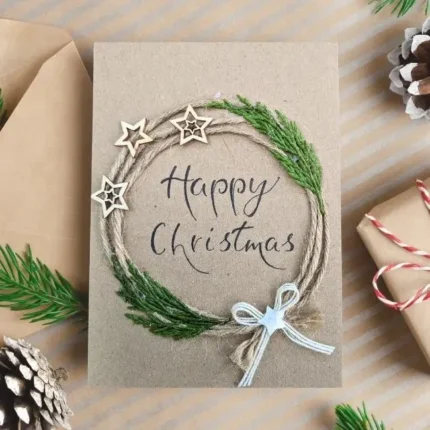 Handmade Happy Christmas card featuring a mix of natural twine and green embroidered wreath with star accents.