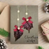 Handmade Heartwarming Christmas card featuring dried leaves and stars, conveying a heartwarming holiday spirit.
