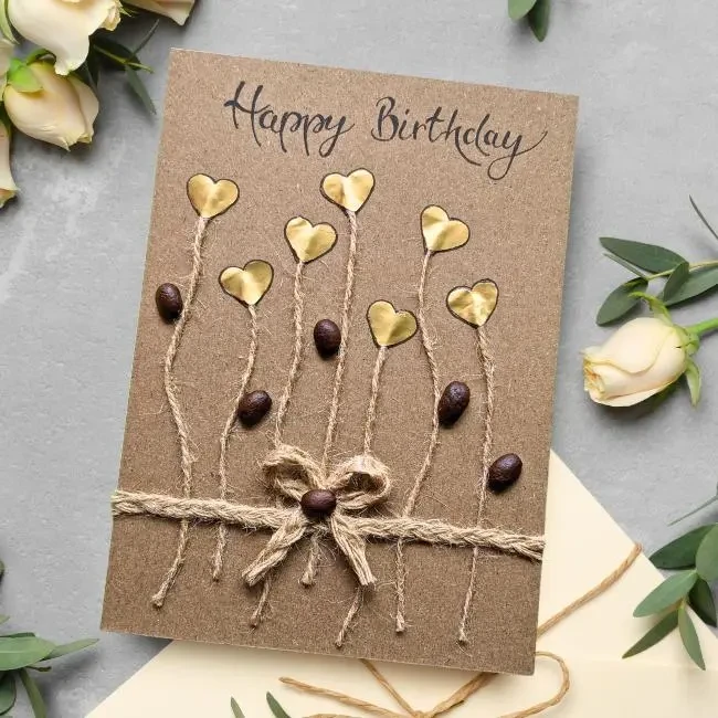 Handmade Personalised Card for Her or His Birthday Handmade Personalised Card for Her or His Birthday card adorned with gold hearts and beans, perfect for celebrating her or his birthday.