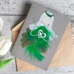 Handmade romantic love card for girlfriend featuring a green and white women holding a heart, designed for a girlfriend.