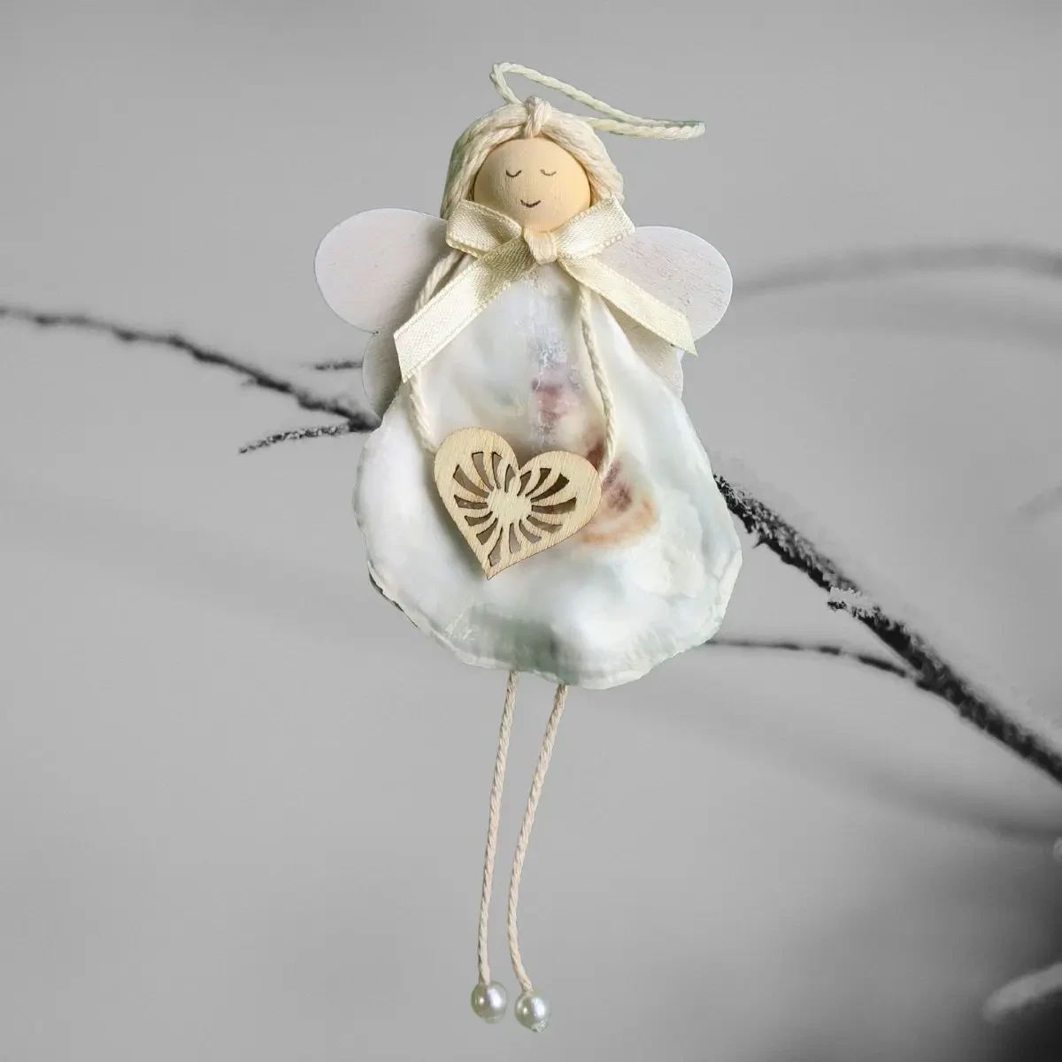 Handmade Seashell Christmas Ornament - A Coastal Christmas Treasure Handmade Seashell Christmas Ornament made of white seashell, wooden heart and wings.