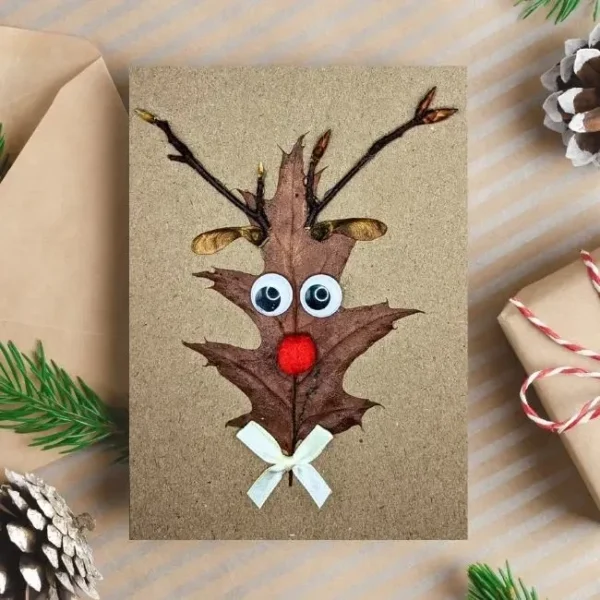 Hilarious Reindeer Christmas Card - handmade from leaves and a wooden stick, with a red nose reindeer design.