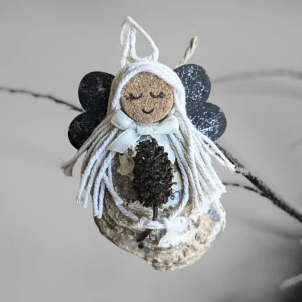 Lovely Unusual Handmade Shell Angel made of seashell, wooden dark wings and white cotton string.