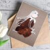 Natural Elegance - Handcrafted Feather Greeting Card Handcrafted feather greeting card made of dry leaves, wood, and white cotton string, featuring a reindeer.