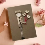 Perfect Handcrafted Card for Your Mother made of seashell and coffee beans on brown paper.