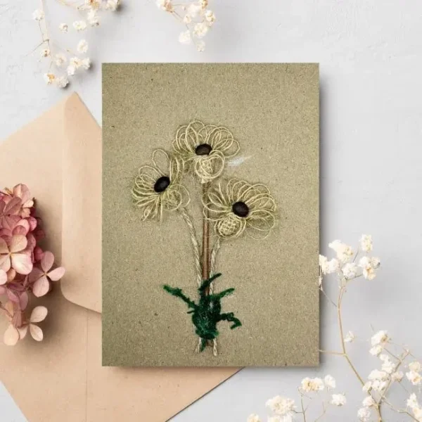 Handmade floral personalised Thank You card adorned with a flower, made of coffee beans, cotton string, and moss.