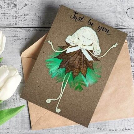 Perfect Greeting Card for Birthday Wishes made of feathers and cotton string on brown eco-friendly paper.