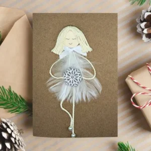 Personalised and Unique Handmade Christmas Card for Wife Personalised and Unique Handmade Christmas card for wife featuring a girl made of a white feather, holding a wooden snowflake.