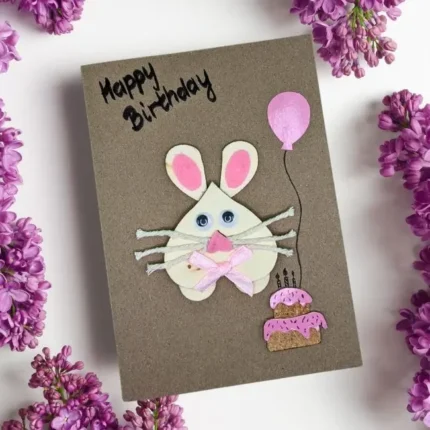 Handmade Adorable Birthday Card with Bunny, pink balloon and birthday cake on brown paper.