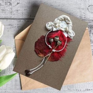 Romantic handmade love card for wife made of red feathers.