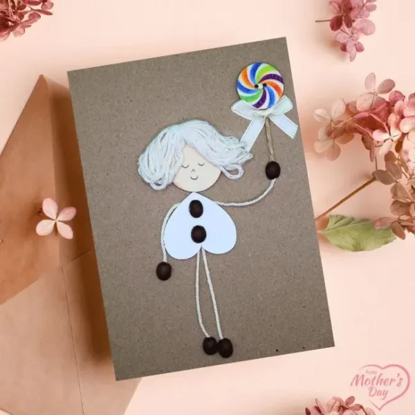 Handmade card for happy mother's day, displaying a cheerfully girl holding a lollipop.