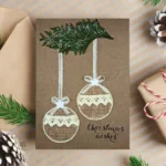 Handmade and cute Christmas card with two festive baubles made of eco-friendly materials.