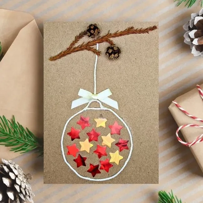 Unique Handmade and Colourful Christmas Ornament Ball Card for Everyone Handmade Christmas Ornament Ball Card is made from recycled cardboard and features a festive ball on a tree branch.