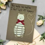 Unique Handmade Birthday Card from Cat to Owner made of wood and cotton string on brown paper.