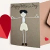 Handmade Happy Father's Day Card idea. The card features a simple yet charming figure of a wooden boy with black hair.