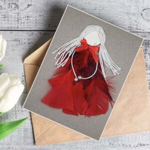 Unique Handmade International Women's Day Card made of read feathers and white cotton string.